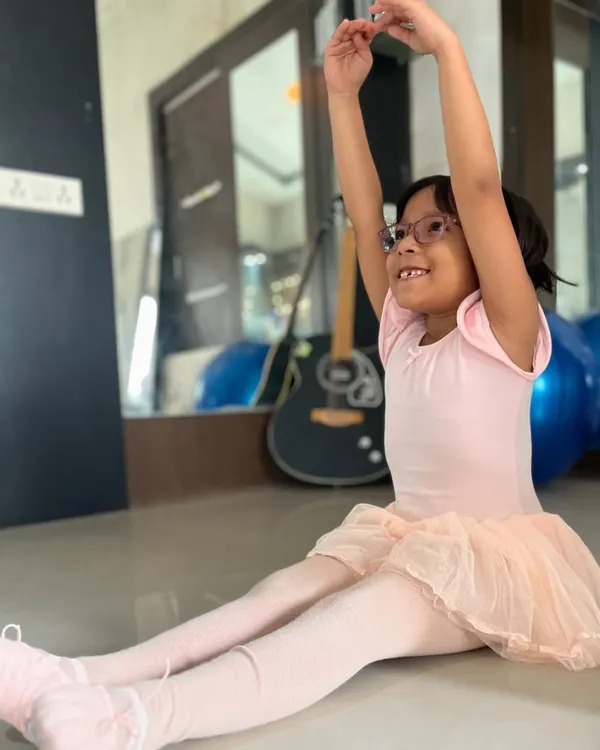 A young ballerina practices her arm positions with a smile. My classes are designed to be enjoyable while teaching the core principles of ballet.