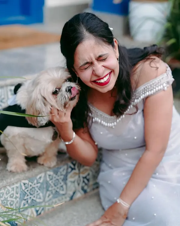 Pure, unscripted joy. Including your furry family members in your shoot is always a great idea, and it often leads to the most genuine and heartwarming moments, like this puppy kiss.