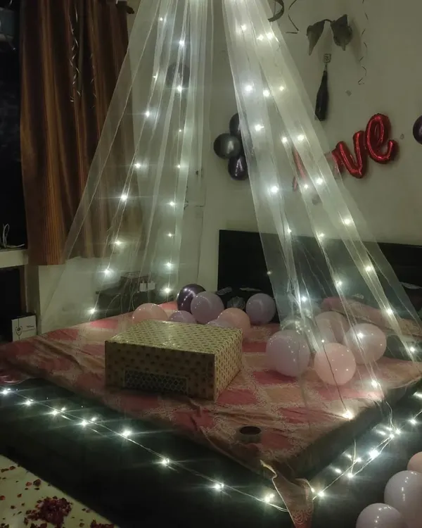 A simple yet magical touch with a fairy light canopy. This design creates a cozy and romantic atmosphere, perfect for setting the scene for a gift-giving moment or a quiet celebration.