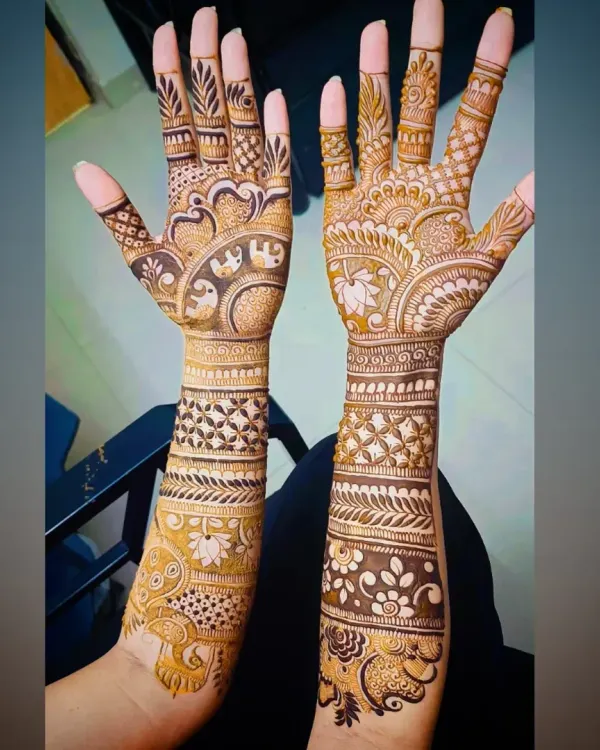 A classic full-arm Indian mehandi design, featuring elephant and peacock motifs, paisleys, and geometric bands for a rich, celebratory look.