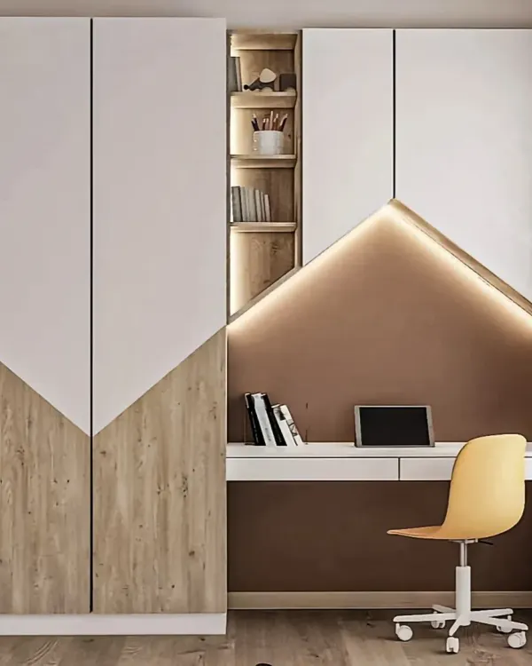 A space-saving modular unit that combines a full-height wardrobe with a compact study desk. The angled design and integrated lighting create a stylish and highly functional corner in a bedroom.