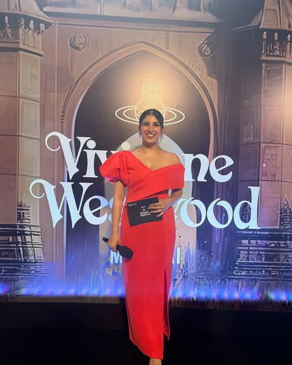 Dressed in a striking red gown, ready to host the Vivienne Westwood Mumbai event. For fashion and lifestyle brands, I bring a glamorous and energetic presence that complements the brand's image.