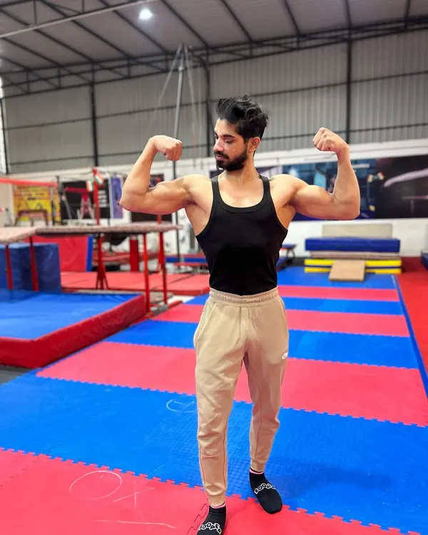 A shot of me, Coach Afjal, at the academy. My goal is to transfer my years of experience as a competitive gymnast to every student who walks through our doors.
