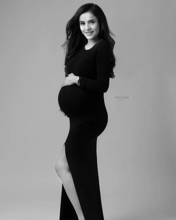 A classic solo portrait in black and white. The simplicity of a form-fitting black dress and clean background creates a sophisticated and timeless image that focuses on your silhouette.