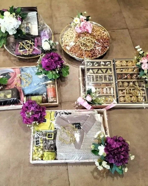 This display showcases the full range of our trousseau packing capabilities. We expertly assemble diverse gifts, including apparel, gourmet dry fruits, and luxury items, into a cohesive and stunning collection for your wedding festivities.