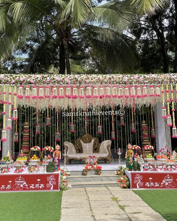 This elegant outdoor Seemantha setup shows how I can transform any space into a beautiful ceremonial venue. The hanging floral arrangements and grand 21-plate display create a truly memorable and auspicious atmosphere.
