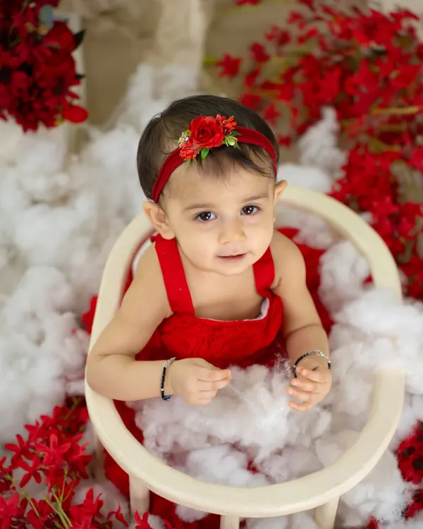 A beautiful, simple portrait of a little girl in red. Her direct gaze and sweet expression are the focus of this lovely shot.