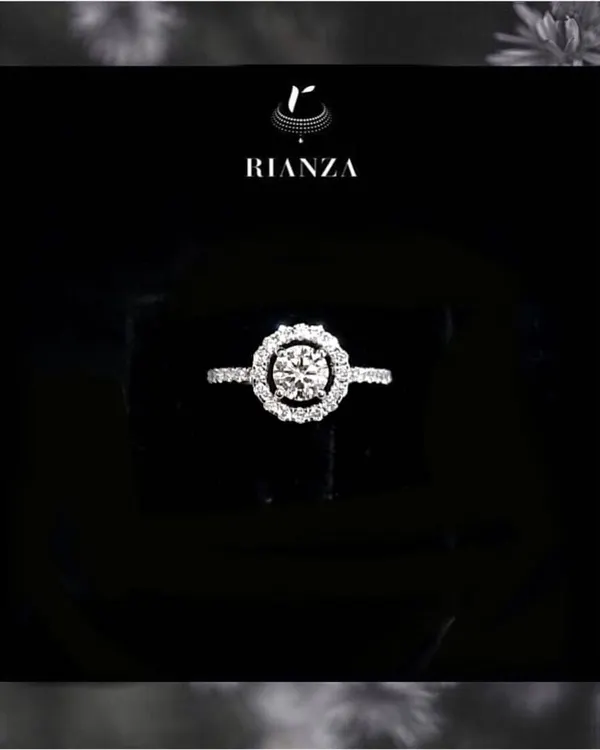 Our most popular design, this is a timeless round brilliant solitaire set in a delicate halo of smaller diamonds. It is a classic and elegant choice for an engagement ring.