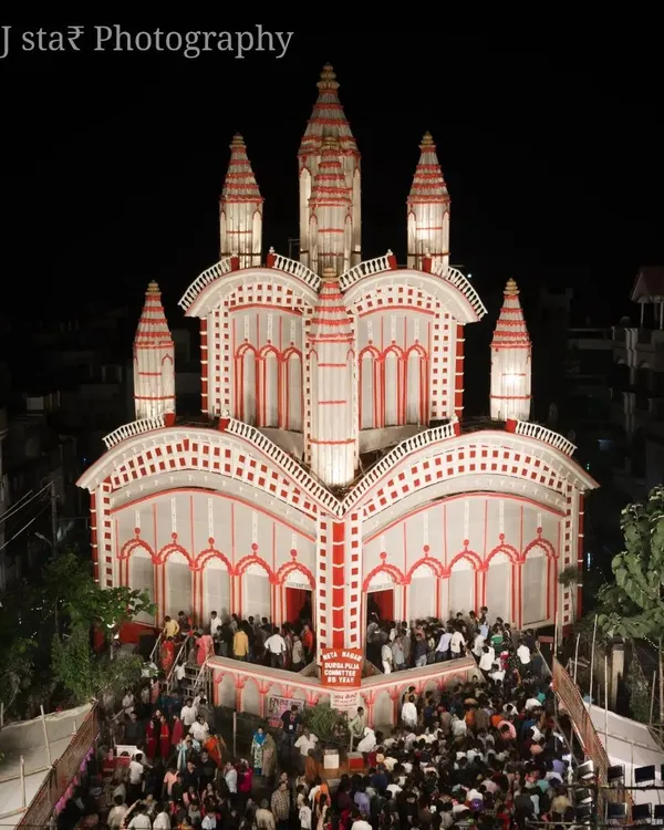 The beauty of Durga Puja is in the details. This is a low-altitude shot of a pandal in Prayagraj, designed with classic red and white Bengali patterns. I make sure to capture the energy of the crowd gathered for darshan.