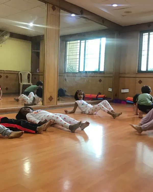 A look at our outdoor program, where we bring "Serious Fun" right to your apartment's doorstep. These images show kids enjoying gymnastics and yoga on mats in both indoor and outdoor community spaces.