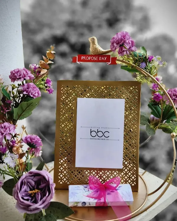 A perfect gift to commemorate a special proposal. This exquisite cutwork photo frame is set within a floral hoop, creating a beautiful display piece for an engagement, anniversary, or Valentine's Day.