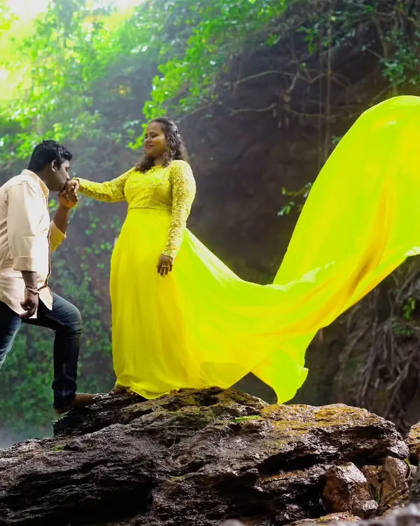 This vibrant yellow flying gown looks incredible against natural backdrops like this waterfall. The long trail adds a burst of color and movement to your pre-wedding or maternity photos.