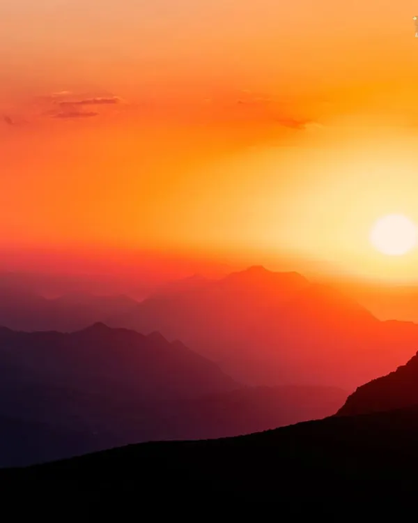 A fiery sunset over layers of mountains. This is the kind of magical view that makes you stop and just be present in the moment.