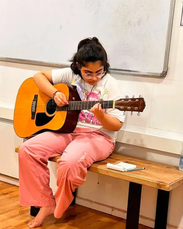 A young guitarist lost in her music during a class at our new Borivali branch. We provide a comfortable space for students to practice and grow.