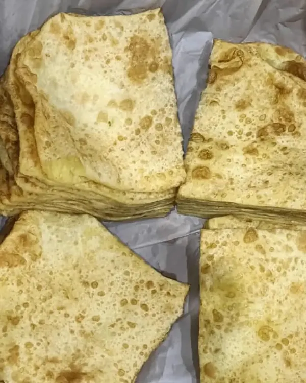 Fresh, soft Rumali Rotis, folded and ready to be served. They are the perfect accompaniment to our rich curries.