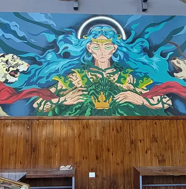 The complete view of our "Mother Nature" mural at Cuppa in Mysore. This piece spans the length of the wall, featuring a central deity flanked by a tiger and a deer, creating a powerful narrative for the space.