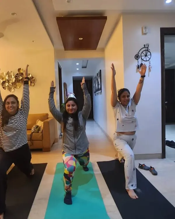 A personal group session at home with some of my dedicated students. We're practicing the warrior pose, a foundational yoga posture for building leg strength and focus.