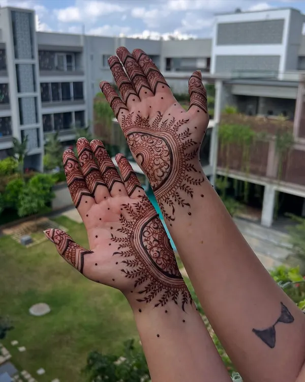 A side view of this intricate mandala design, showing how the pattern extends to the wrist. The shading and line work create a beautiful, three-dimensional effect.