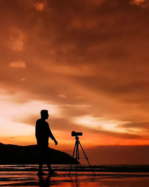 A silhouette of me with my camera on a tripod against a beautiful sunset on the beach. This image represents my identity as a filmmaker, always in search of the perfect light and moment.