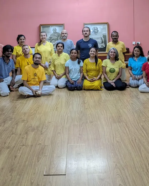When you join our course, you become part of a global family. This is a photo of our dedicated staff and teachers at the Sivananda South Delhi center. We are here to support your growth and welcome you into our vibrant yoga community.