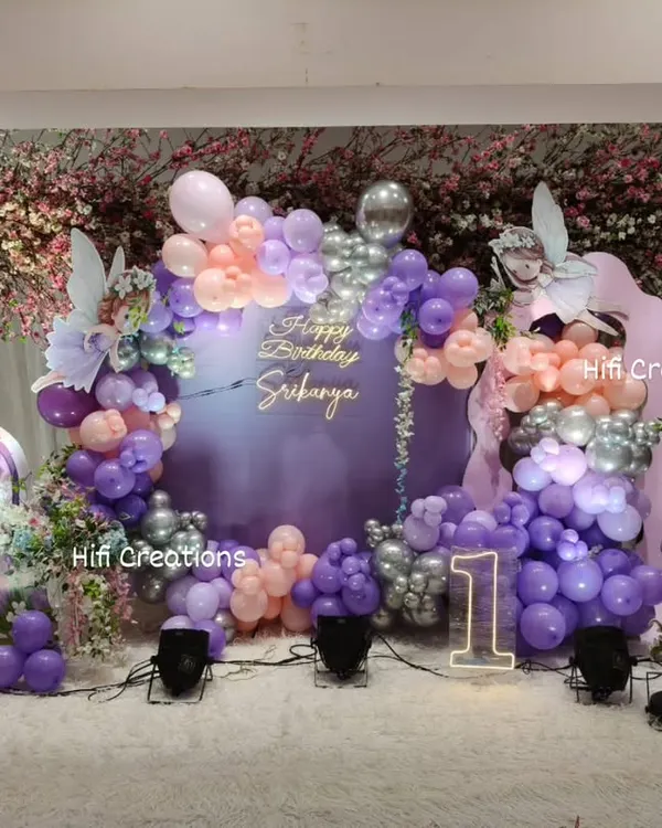 This enchanting fairy-themed first birthday is one of our signature large-scale setups. We created a magical wonderland with custom props like a fairy door and mushroom house, a full balloon arch, and soft lighting to make the celebration truly unforgettable.