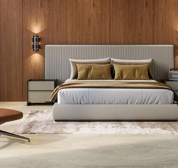 This minimal bedroom design combines a plush upholstered bed with a warm wood accent wall and a comfortable leather reading chair. The result is a sophisticated and calming space that feels like a luxury hotel suite.