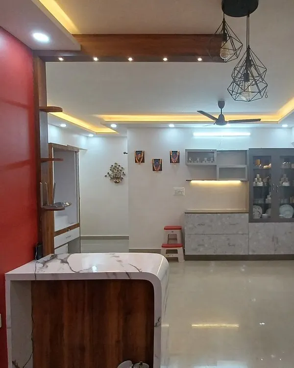A vibrant living area brought to life with a bold red accent wall and crisp white surroundings. We specialize in creating modern, clean looks that combine flawless painting with strategic lighting and design to make your home feel brand new.