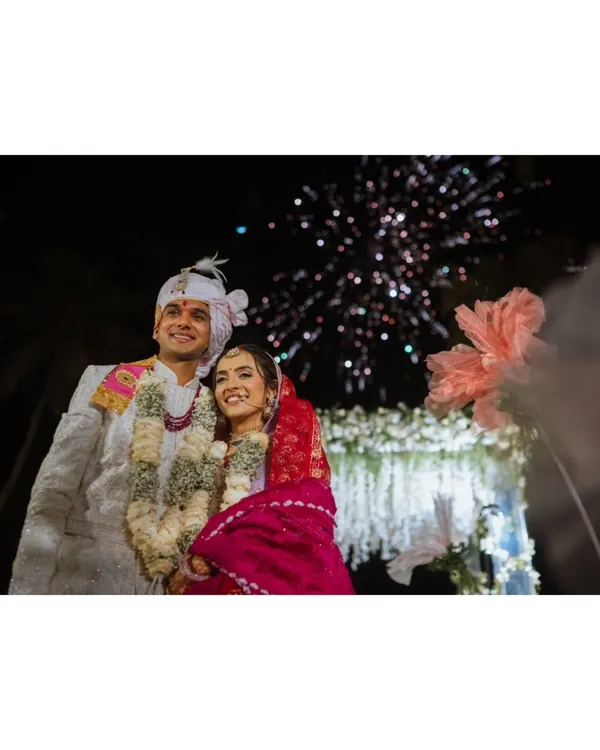 A stunning shot of the couple under a burst of fireworks, marking a magical end to their wedding day.