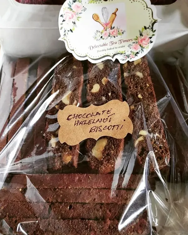 A freshly packed batch of our Chocolate Hazelnut Biscotti. You can see the generous chunks of hazelnut in each slice, all handmade by our BakeStar from Delectable Tea Timers in Andheri West.