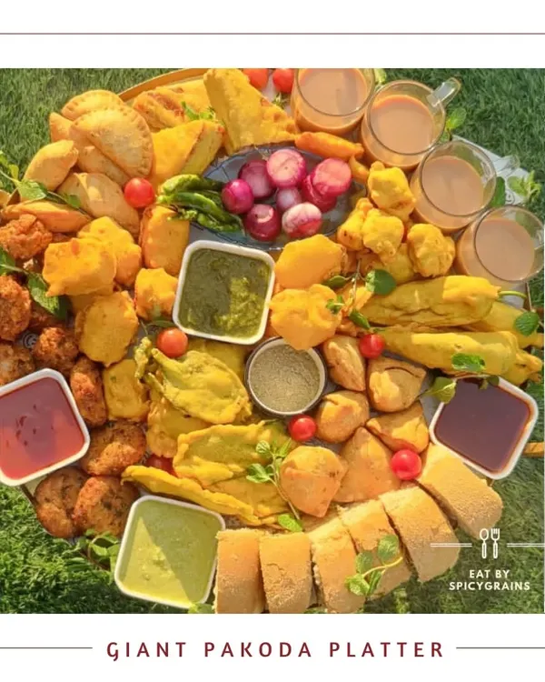Our Giant Pakoda Platter is the ultimate comfort food indulgence. We gather a massive assortment of freshly fried pakodas, samosas, and bread rolls, served with a variety of chutneys and steaming hot chai for the perfect rainy day or high tea party.