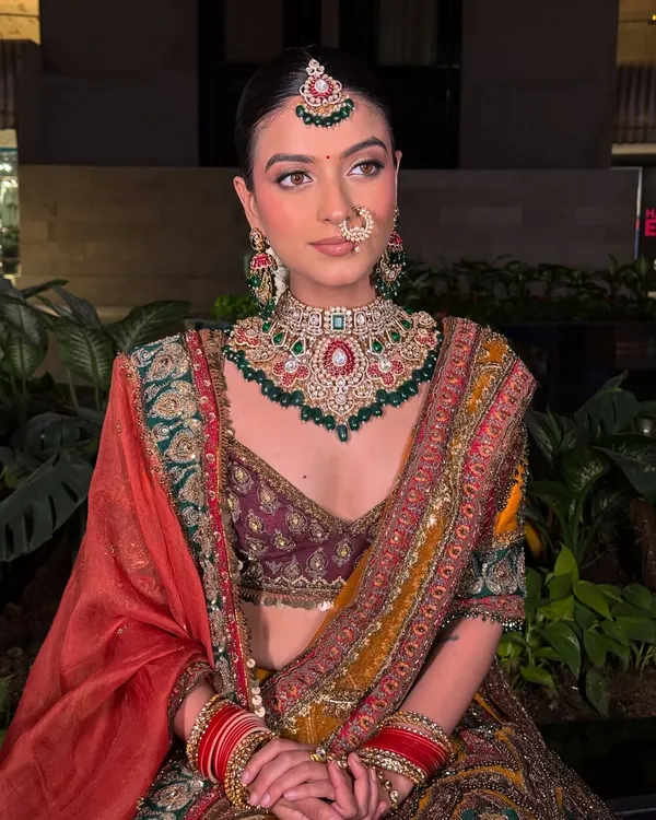 A full-length view of this gorgeous bridal look. The multi-hued lehenga is perfectly complemented by the intricate Kundan choker set, creating a timeless and regal final shot for any portfolio.
