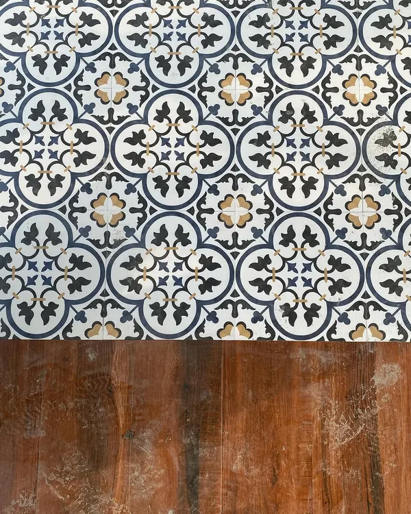 We love mixing materials to create visual interest. Here, you can see the beautiful contrast between the intricate, Moroccan-style patterned tiles and the warm, rustic texture of the hardwood decking we used in our Pioneer Araya project.