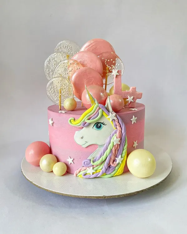 Be a unicorn in a field of horses! This magical unicorn cake features a hand-sculpted bas-relief unicorn with a pastel rainbow mane, surrounded by isomalt lollipops and chocolate spheres.