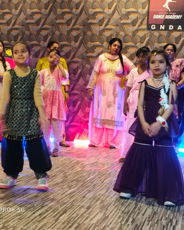 A close-up of our young performers during a workshop. Dressed in colorful traditional outfits, these kids are ready to showcase their new dance skills with confidence and big smiles.