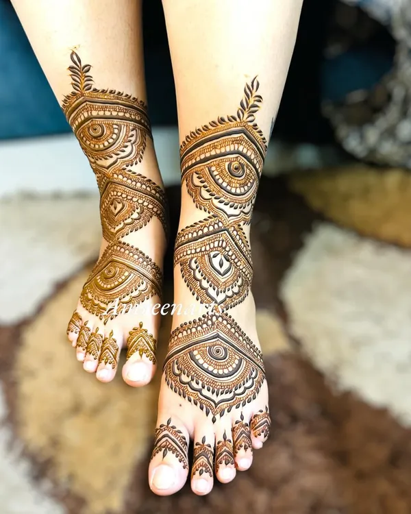 Beautiful bridal feet adorned with intricate geometric and eye-inspired patterns. This style of mehandi provides full coverage and a very traditional look.