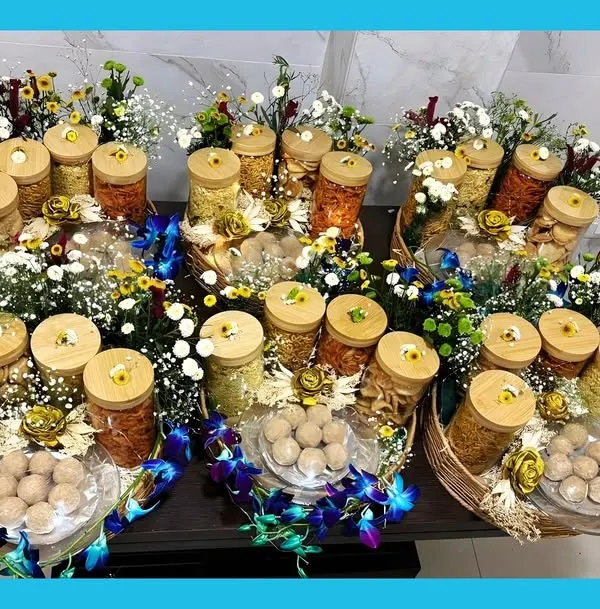 This is what pure celebration looks like. I prepared these custom winter hampers, each filled with four types of savory namkeen, my signature Gond ke Laddu, and decorated with fresh flowers. It’s my bestseller and shows how I can handle beautiful bulk orders for any occasion.