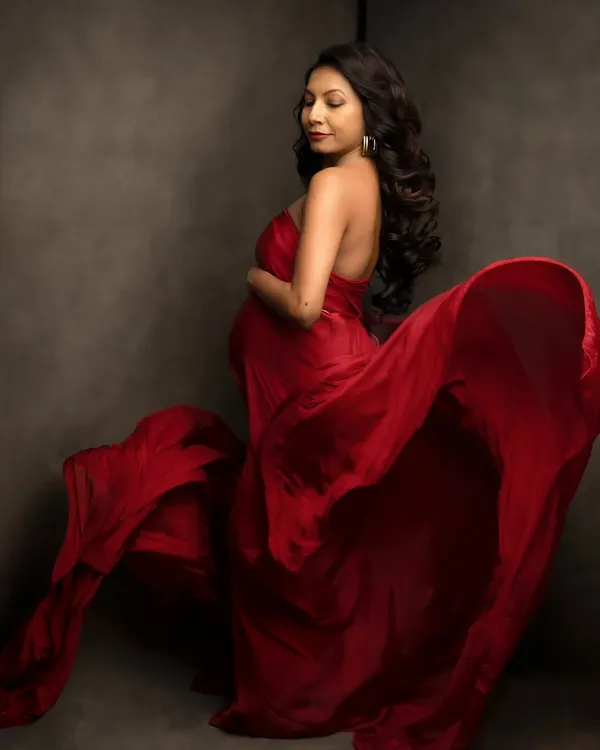 The magic of a single piece of fabric. We use silks like this to create a sense of movement and drama, turning a simple portrait into a work of art. This flowing red is a studio favorite.