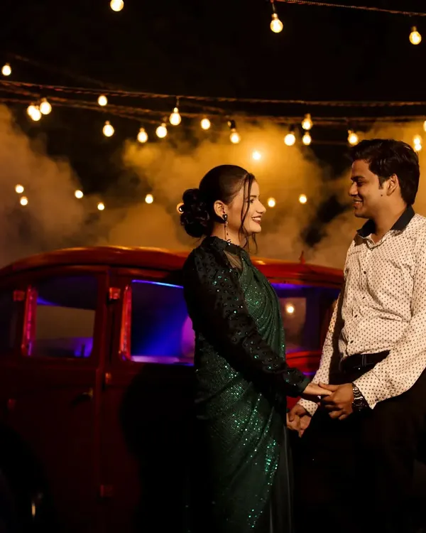 I create stunning cinematic night shoots using professional lighting, atmospheric smoke, and props like this vintage car. This style is perfect for couples wanting dramatic and romantic pre-wedding portraits.