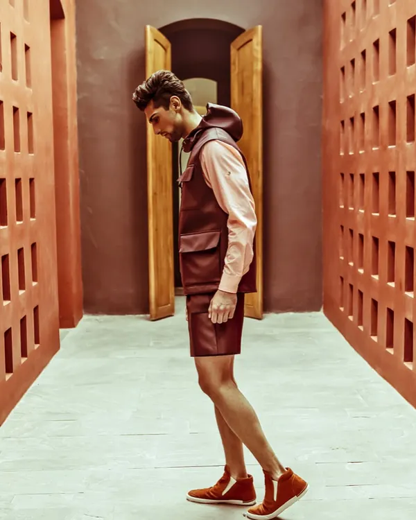 A throwback to an editorial series for The Man magazine. This look features a leather utility vest and shorts from Dior, showcasing a high-fashion, utilitarian aesthetic.