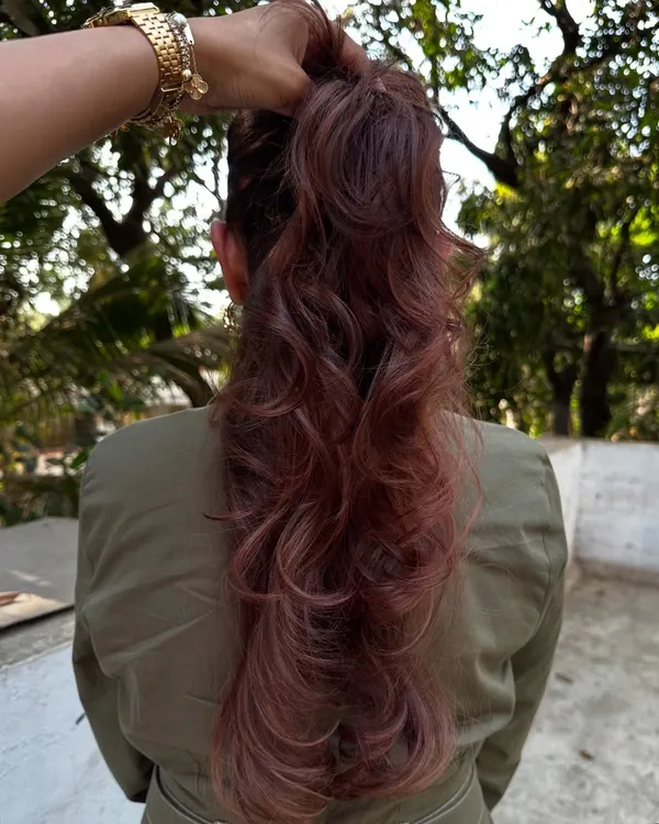 A 'Rose Gold' dream come true. We transformed her faded highlights into this stunning metallic pink shade. It’s a trendy yet sophisticated way to play with color.