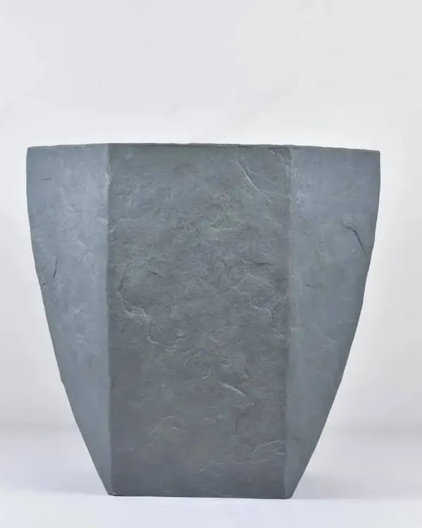 A modern, hexagonal fiber planter with a stone-like finish. These are lightweight, durable, and perfect for both indoor and outdoor use.