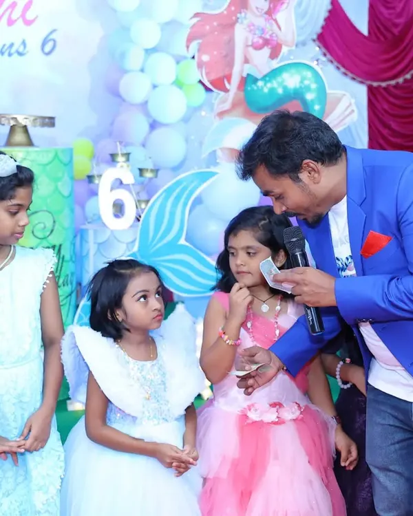 Performing a little close-up magic for the kids at a birthday party. It's always a joy to see their amazed faces and make the event more magical for them.