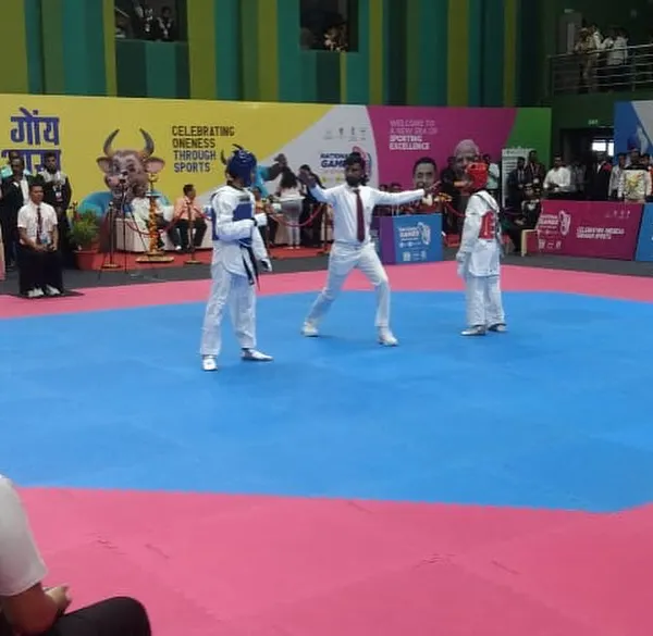 I command the ring at the National Games in Goa, signaling the start of a match. As the central referee, my presence ensures that the competition adheres strictly to the established rules of Taekwondo.