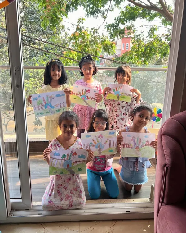 Look at this amazing group of artists! They are all so proud to show off the imaginative houses they created from a simple hand outline.