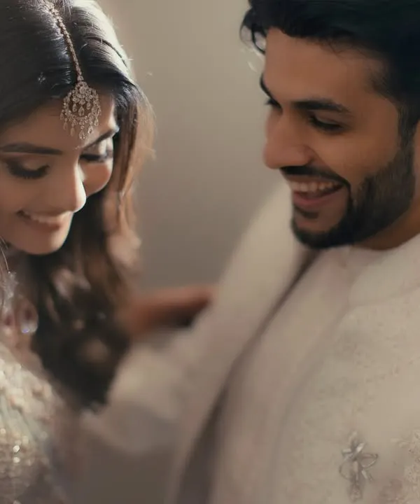 It's the small, unscripted gestures that we love to capture. This candid shot of a shared smile and a gentle touch on the shoulder speaks volumes about their easy, comfortable love.