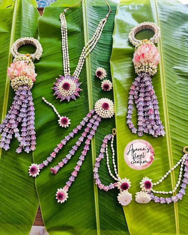 This is a complete floral jewellery set I designed for a Haldi ceremony. It includes a necklace, earrings, a maang tikka, and hand jewellery, all intricately crafted for a beautiful, coordinated bridal look.