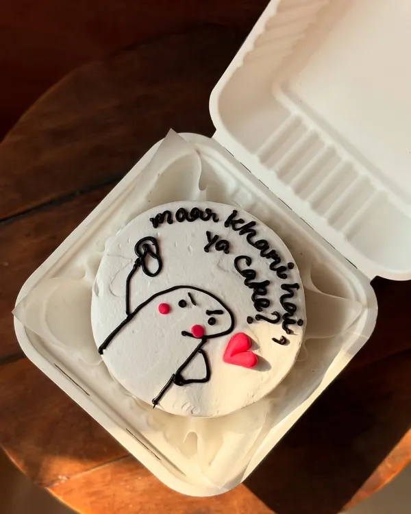 One of my favorite funny bento cakes, perfect for a friend who loves a good laugh. This design features a popular meme character, all hand-piped with chocolate on a smooth buttercream surface.