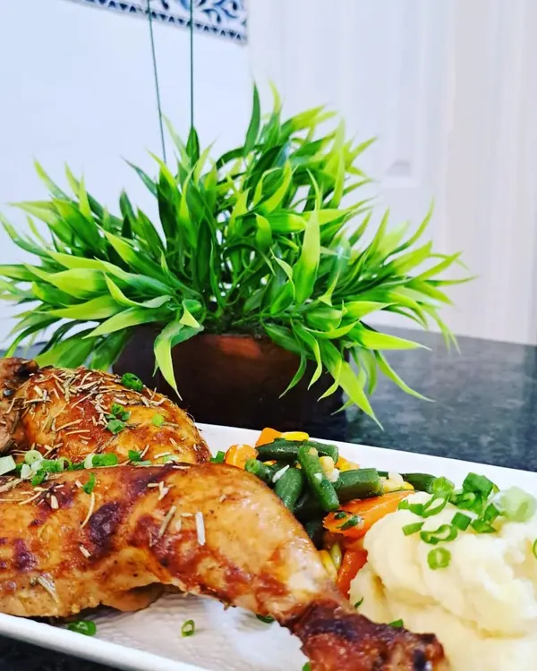 My Rosemary and Garlic Roast Chicken is a dish to remember, with a tantalizing aroma and incredible flavor. I serve the tender chicken legs with creamy mash and buttered vegetables for a complete gourmet meal.