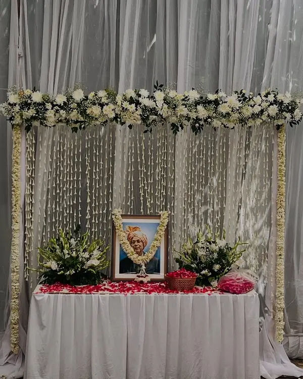 A serene and respectful memorial setup. I created a frame of white flowers with a backdrop of hanging 'rajnigandha' strings to pay tribute.