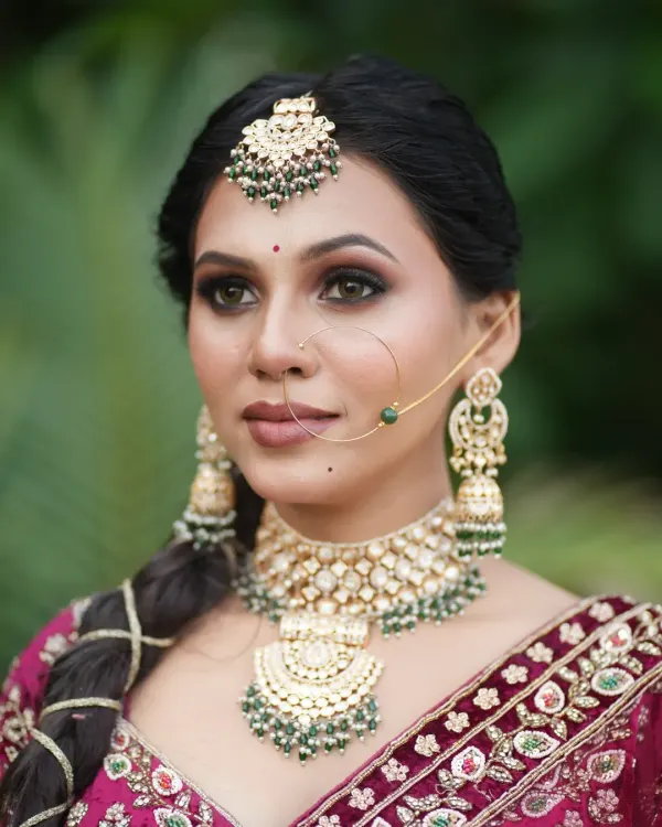 This is the kind of flawless, professional bridal makeup you will learn to create. This traditional look, captured without any filters or edits, features a soft-glam smokey eye, perfectly blended base, and is complemented by heavy kundan and emerald jewelry. My goal is to teach you how to create stunning, real-world results.